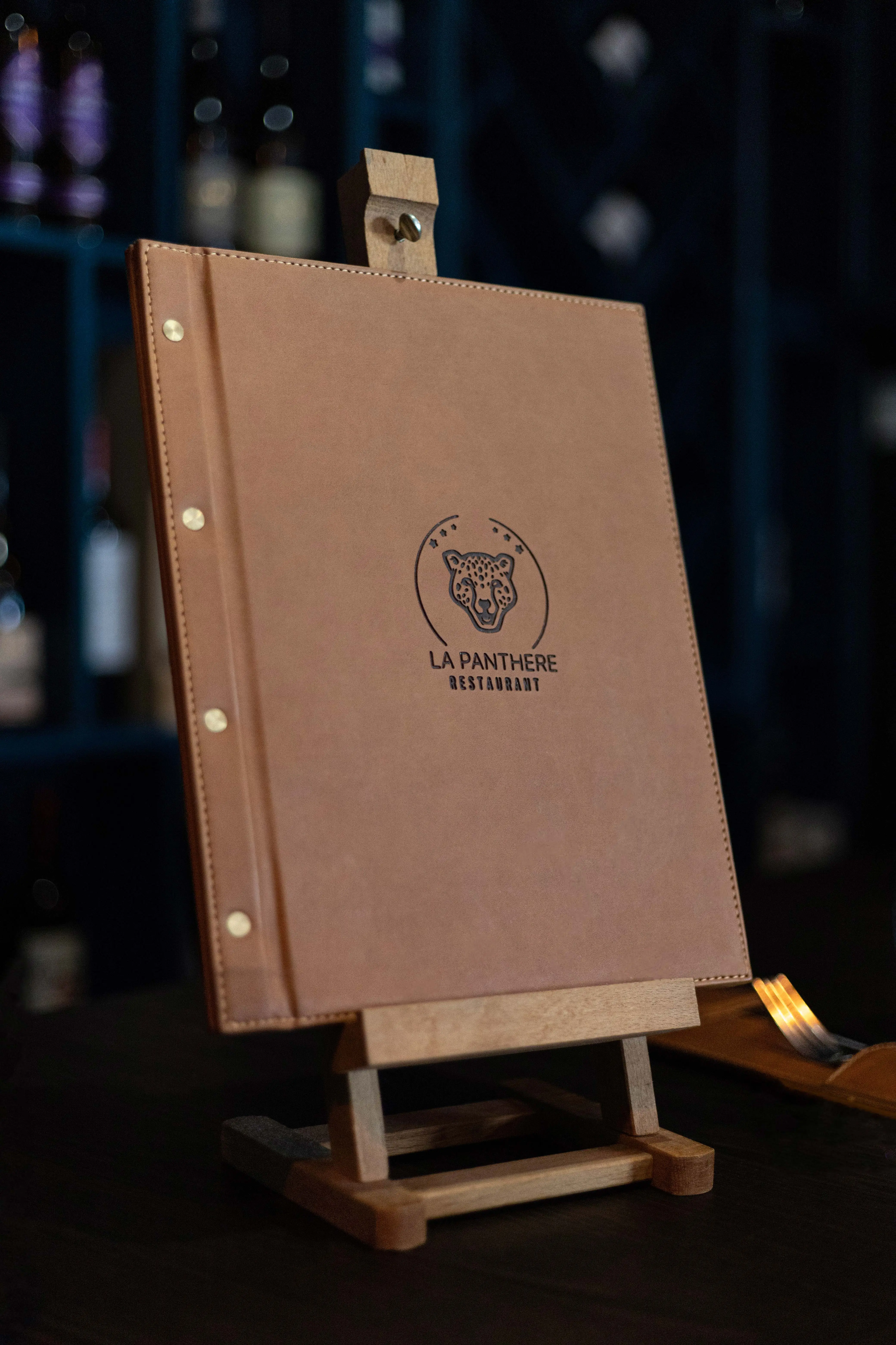 The restaurant's menu, leather cover with panther logo
