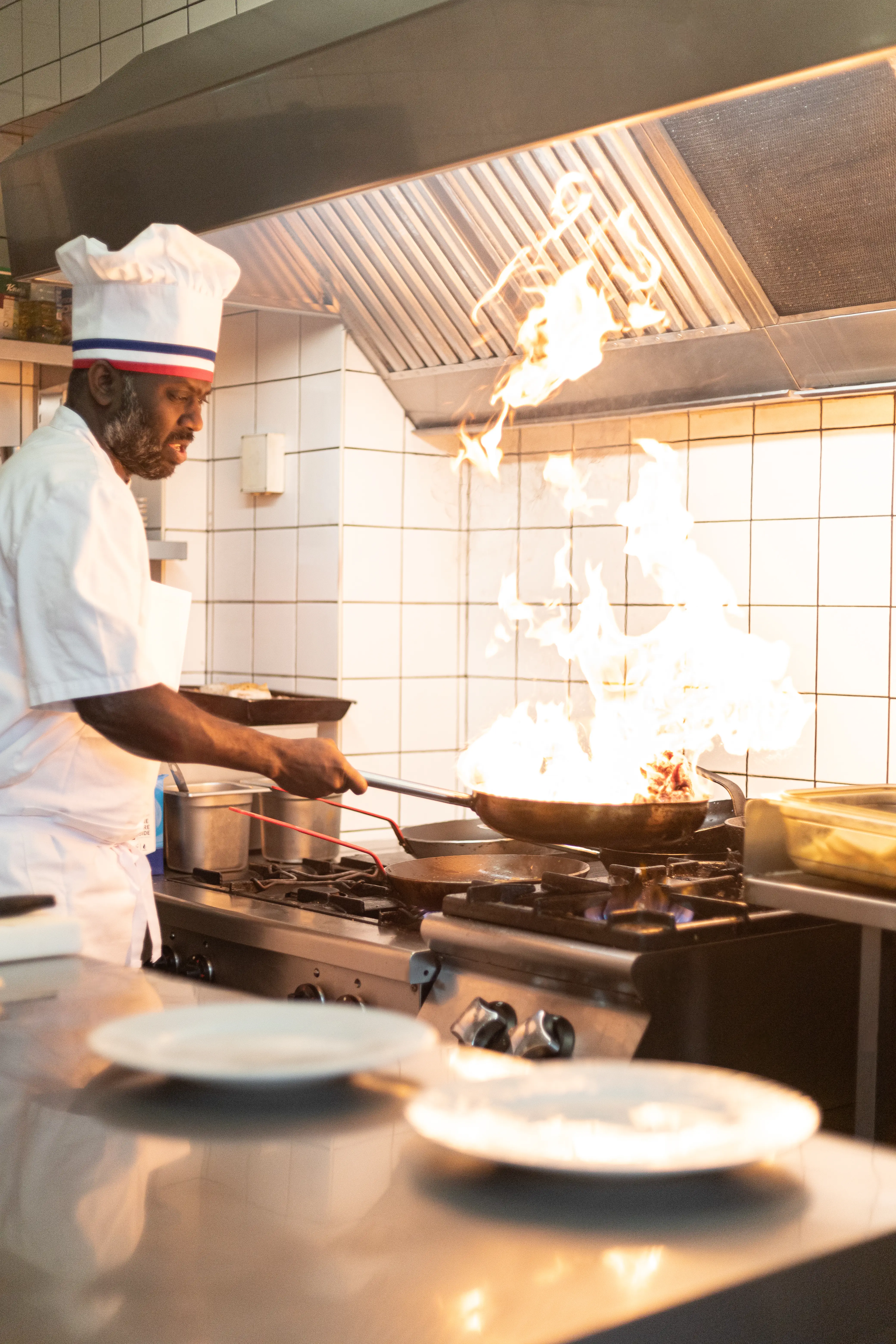 The chef flambés an onglet with cognac in the kitchen