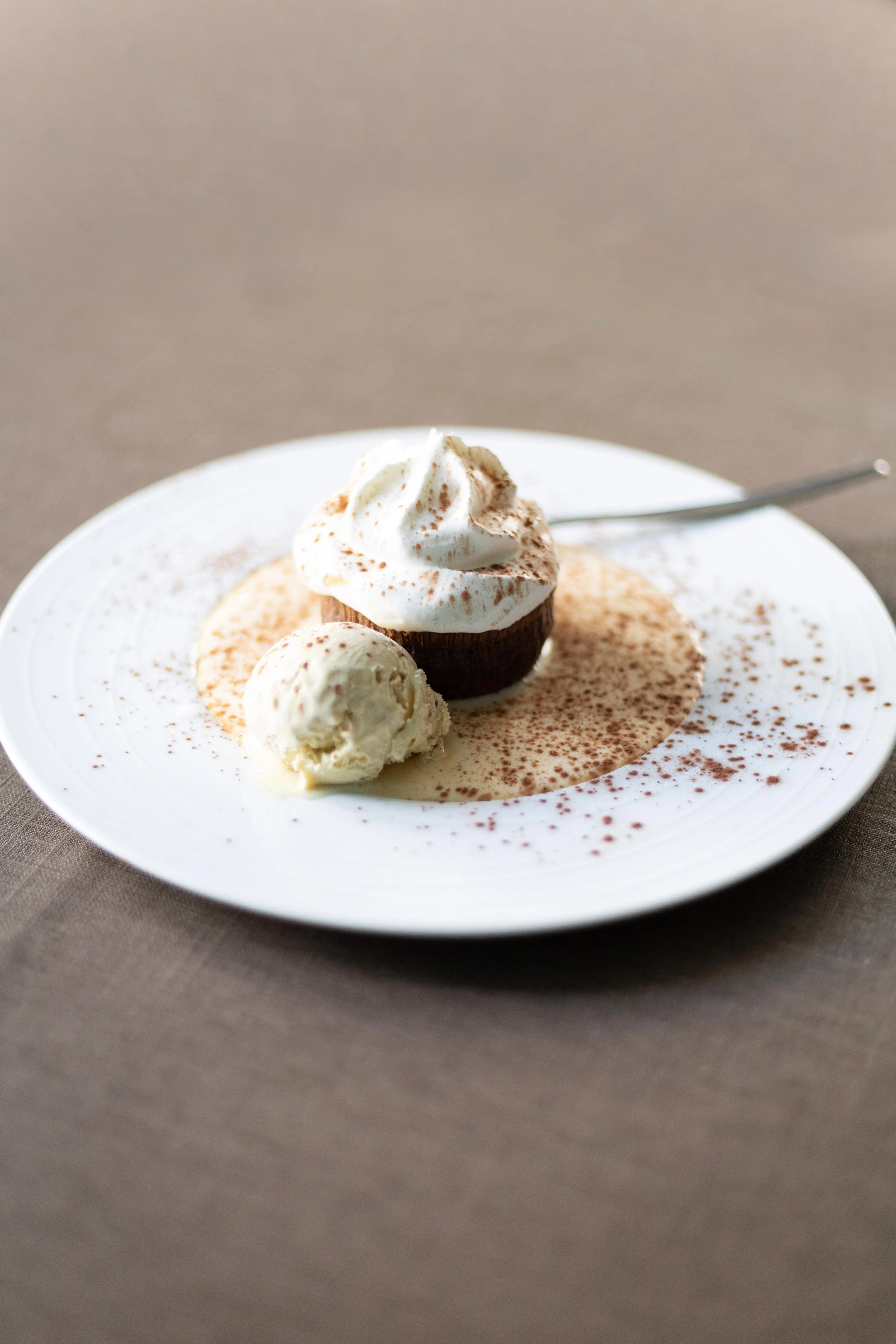 Chocolate fondant, ice cream, whipped cream, crème anglaise, cinnamon