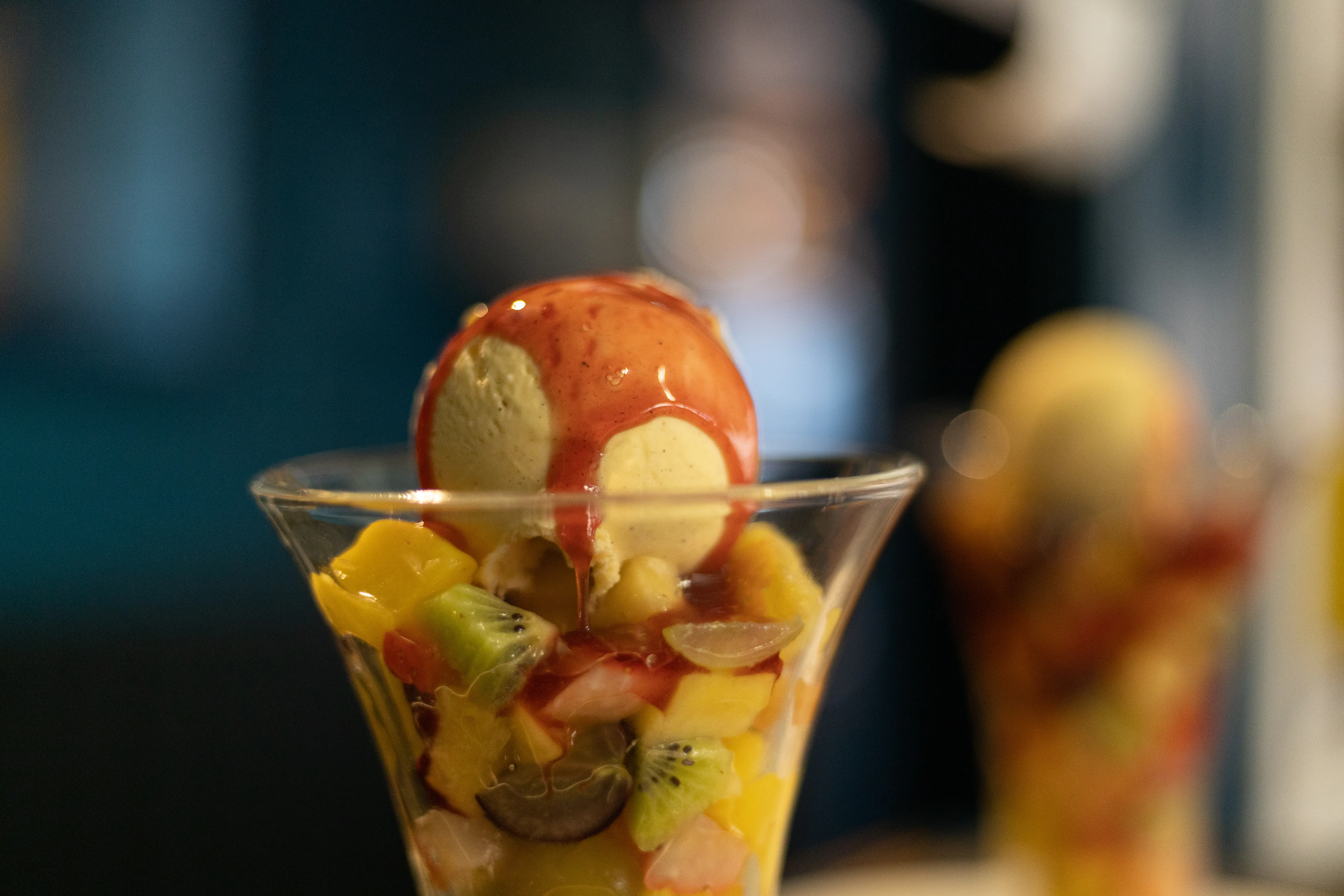 Fruit salad, scoop of ice cream and coulis