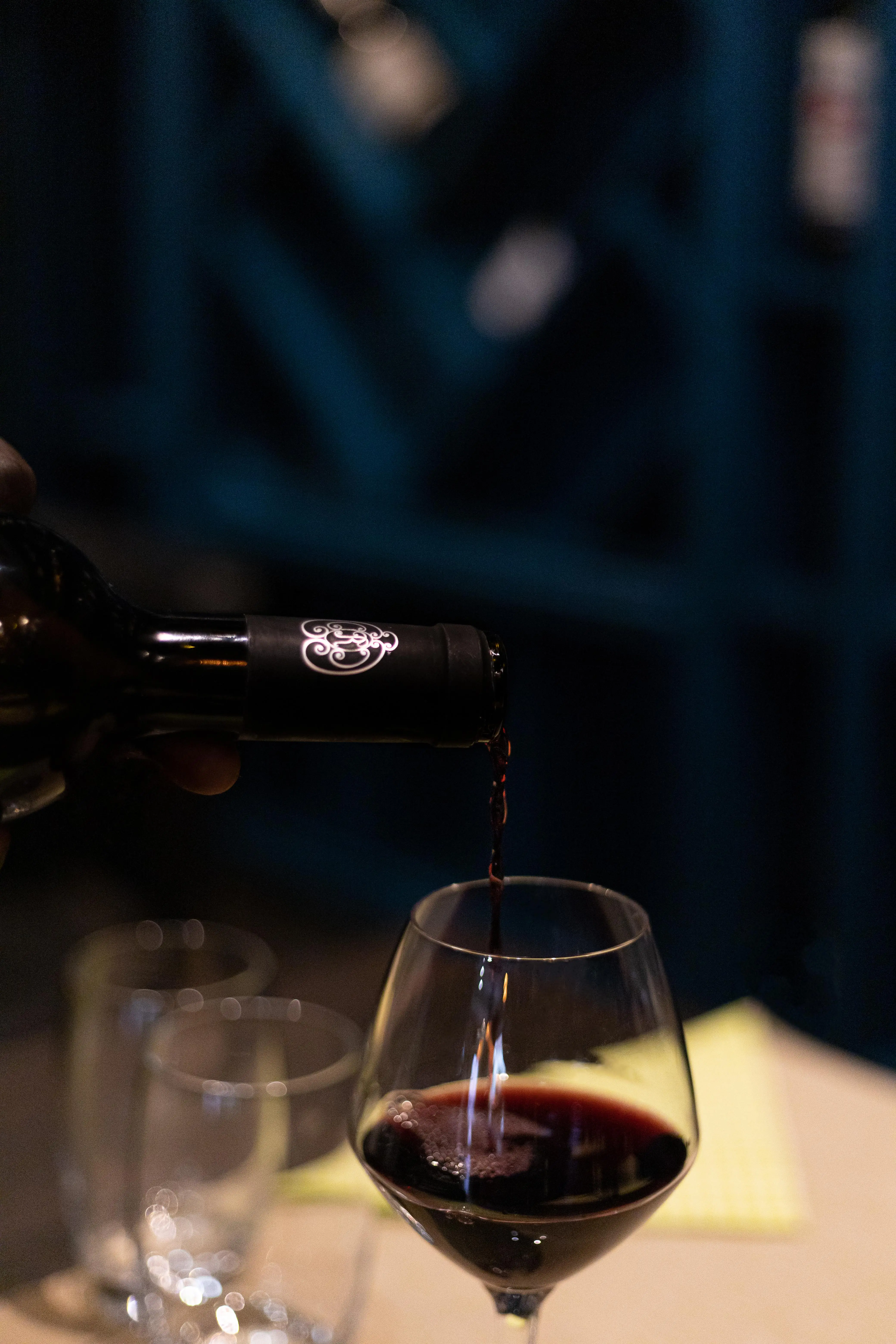 Red wine being served at the table — the welcoming atmosphere of the restaurant