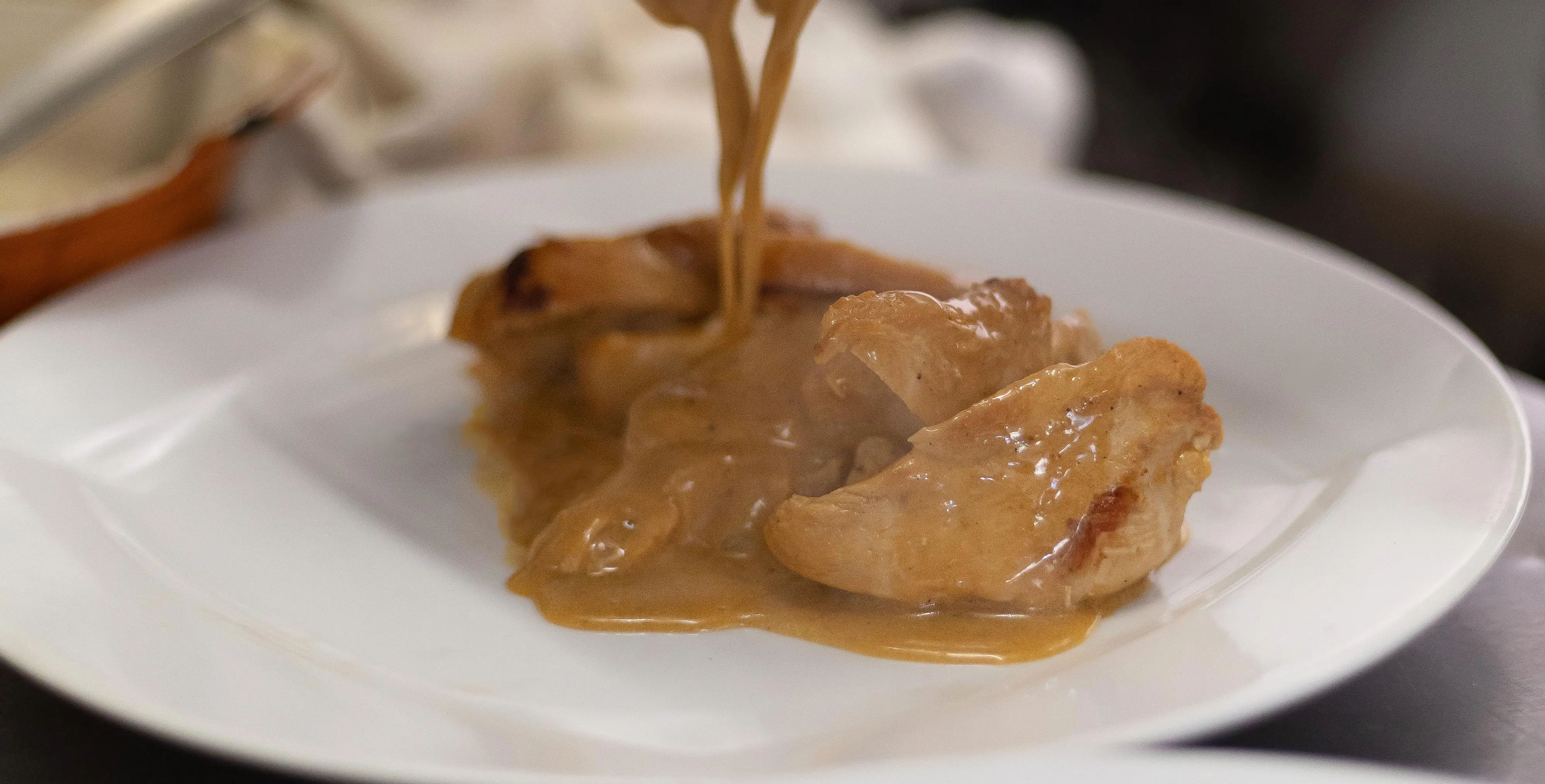 Poultry coated in a creamy sauce